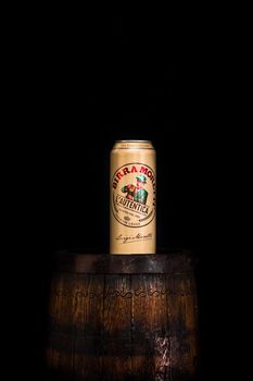 Can of Birra Moretti beer on wooden barrel with dark background. Illustrative editorial photo Bucharest, Romania, 2021