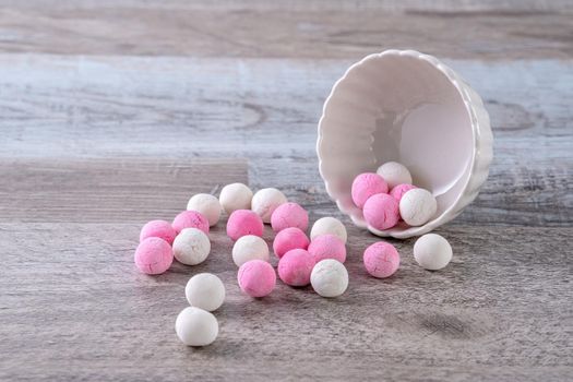 Raw red and white tangyuan glutinous rice dumpling balls on wooden table background for Winter solstice festival food.