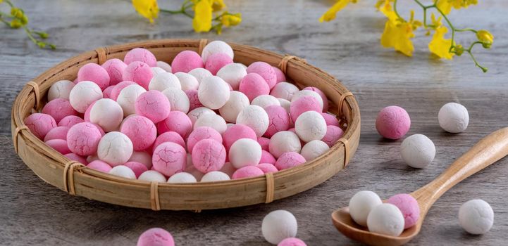 Raw red and white tangyuan glutinous rice dumpling balls on wooden table background for Winter solstice festival food.