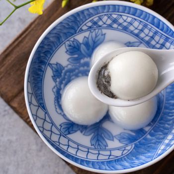 Top view of big tangyuan yuanxiao (glutinous rice dumpling balls) for lunar new year festival food, words on the golden coin means the Dynasty name it made.