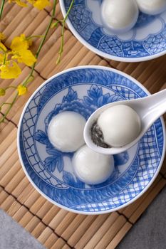 Top view of big tangyuan yuanxiao (glutinous rice dumpling balls) for lunar new year festival food, words on the golden coin means the Dynasty name it made.