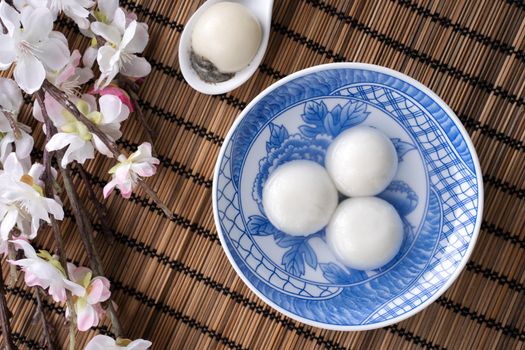 Top view of big tangyuan yuanxiao (glutinous rice dumpling balls) for lunar new year festival food, words on the golden coin means the Dynasty name it made.