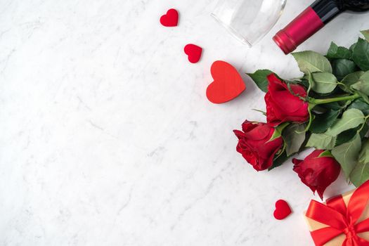 Top view of Valentine day gift with rose and wine, festive design concept for special holiday dating meal.