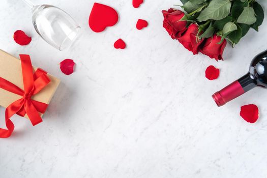 Top view of Valentine day gift with rose and wine, festive design concept for special holiday dating meal.