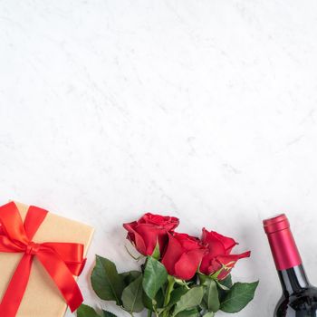 Top view of Valentine day gift with rose and wine, festive design concept for special holiday dating meal.