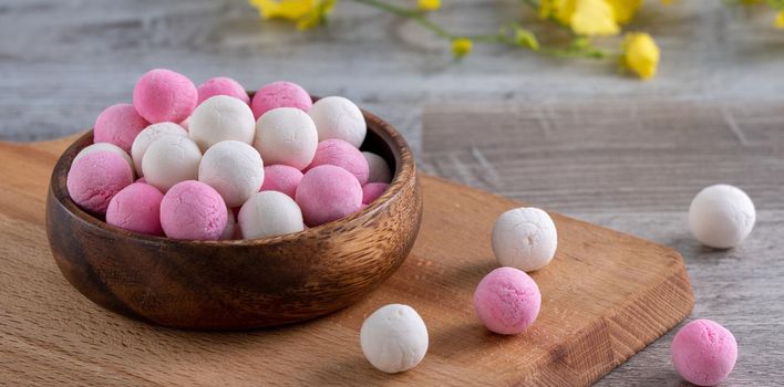 Raw red and white tangyuan glutinous rice dumpling balls on wooden table background for Winter solstice festival food.