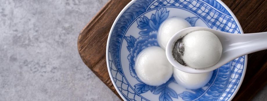 Top view of big tangyuan yuanxiao (glutinous rice dumpling balls) for lunar new year festival food, words on the golden coin means the Dynasty name it made.