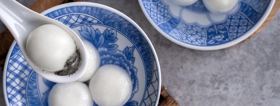 Top view of big tangyuan yuanxiao (glutinous rice dumpling balls) for lunar new year festival food, words on the golden coin means the Dynasty name it made.
