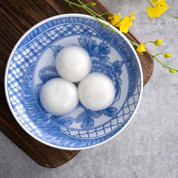Top view of big tangyuan yuanxiao (glutinous rice dumpling balls) for lunar new year festival food, words on the golden coin means the Dynasty name it made.