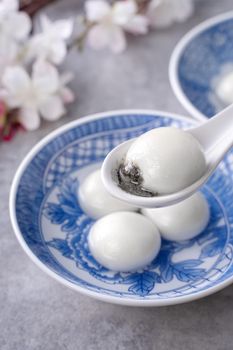 Close up of big tangyuan yuanxiao (glutinous rice dumpling balls) for Winter Solstice festival food on gray table background.