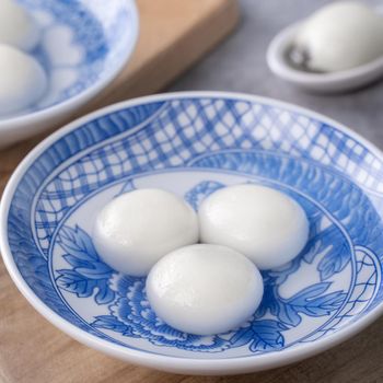 Close up of big tangyuan yuanxiao (glutinous rice dumpling balls) for Winter Solstice festival food on gray table background.