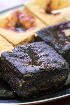 Deep fried stinky tofu, fermented bean curd with pickled cabbage vegetable, famous and delicious street food in Taiwan, lifestyle.
