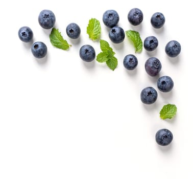 Blueberry fruit top view isolated on a white background, flat lay overhead layout with mint leaf, healthy design concept.