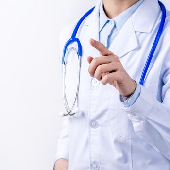 Female doctor body part with hand gesture, young woman physician with stethoscope isolated on white background, close up, cropped view, copy space