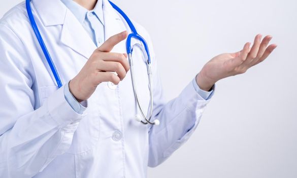 Female doctor body part with hand gesture, young woman physician with stethoscope isolated on white background, close up, cropped view, copy space