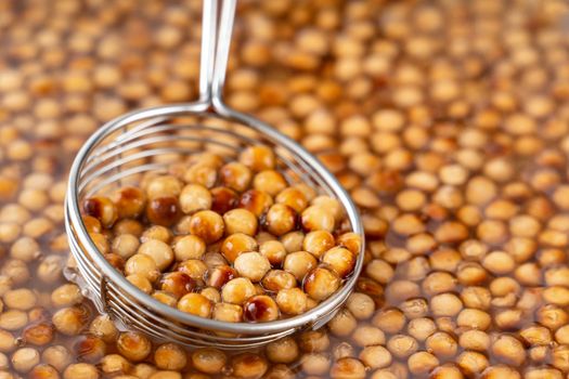 Cooking, boiling brown sugar flavor tapioca pearl balls, ingredient of bubble tea, preparing food and drink, close up, recipe cookbook steps design concept.