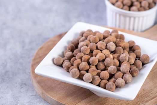 Dry raw brown tapioca pearls isolated on gray cement concrete background, close up, ingredient of making bubble boba tapioca milk tea.