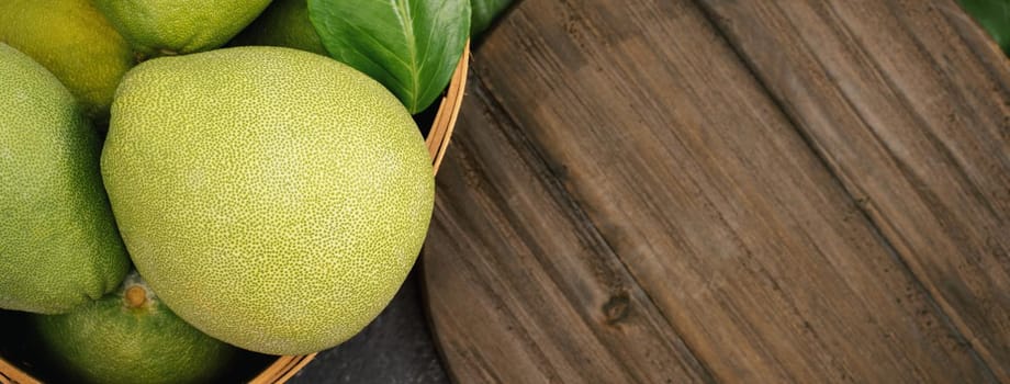 Fresh pomelo, pummelo, grapefruit, shaddock on black background, fruit for Mid-autumn festival, top view, flat lay.