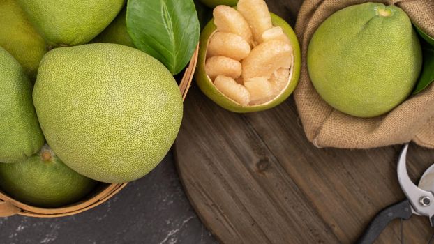 Fresh pomelo, pummelo, grapefruit, shaddock on black background, fruit for Mid-autumn festival, top view, flat lay.