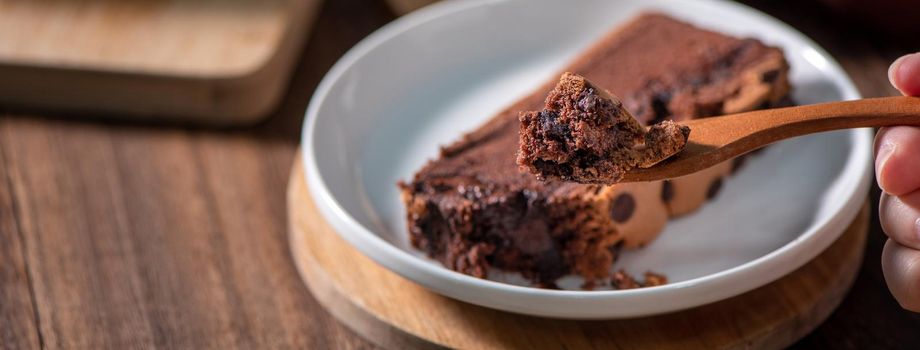 Chocolate flavor Taiwanese traditional sponge cake (Taiwanese castella kasutera) on a wooden tray background table with ingredients, close up.