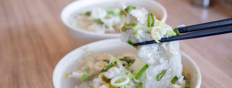 Delicious fish ball rice noodles in thick soup, common food in Tainan, Taiwan, Asia, Asian Taiwanese street delicacy cuisine, close up, lifestyle.