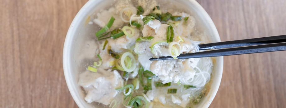 Delicious fish ball rice noodles in thick soup, common food in Tainan, Taiwan, Asia, Asian Taiwanese street delicacy cuisine, close up, lifestyle.
