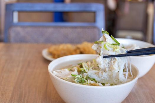 Delicious fish ball rice noodles in thick soup, common food in Tainan, Taiwan, Asia, Asian Taiwanese street delicacy cuisine, close up, lifestyle.