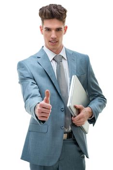 Handsome well-dressed young businessman expressing his success with thumb up, isolated on white background.