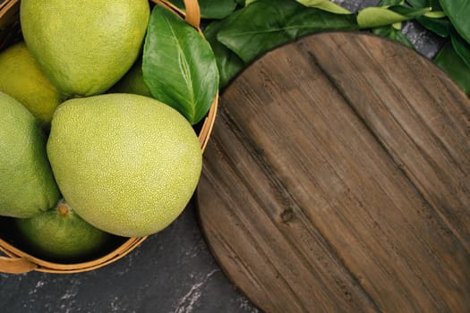 Fresh pomelo, pummelo, grapefruit, shaddock on black background, fruit for Mid-autumn festival, top view, flat lay.