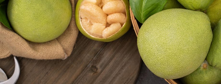 Fresh pomelo, pummelo, grapefruit, shaddock on black background, fruit for Mid-autumn festival, top view, flat lay.