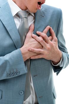 Close-up of young businessman having chest pain and heart attack, with hands holding the painful place.