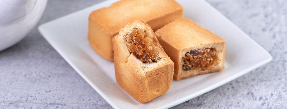 Pineapple cake pastry - Taiwanese famous sweet delicious dessert food with tea, close up, copy space design.