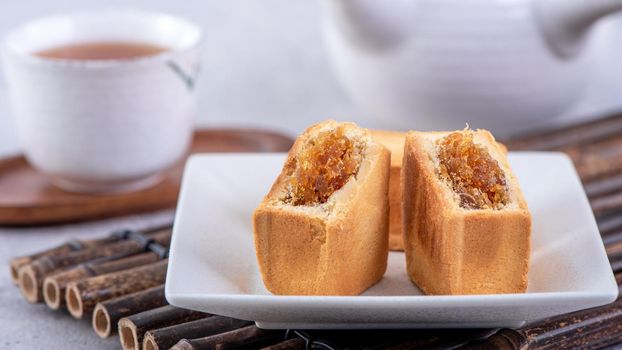 Pineapple cake pastry - Taiwanese famous sweet delicious dessert food with tea, close up, copy space design.