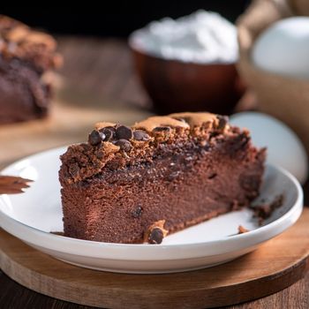 Chocolate flavor Taiwanese traditional sponge cake (Taiwanese castella kasutera) on a wooden tray background table with ingredients, close up.