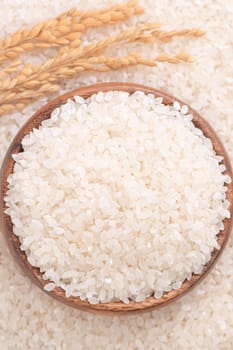 Raw rice in a bowl and full frame in the white background table, top view overhead shot, close up