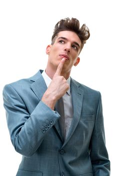 Portrait of handsome young business man having creative idea holding a finger on his lip, isolated on white background. 