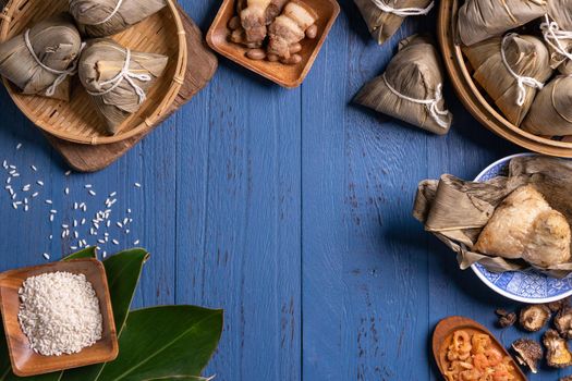 zongzi - Dragon Boat Festival concept Rice dumpling, traditional Chinese food on blue wooden background for Duanwu Festival, top view, flat lay design concept.