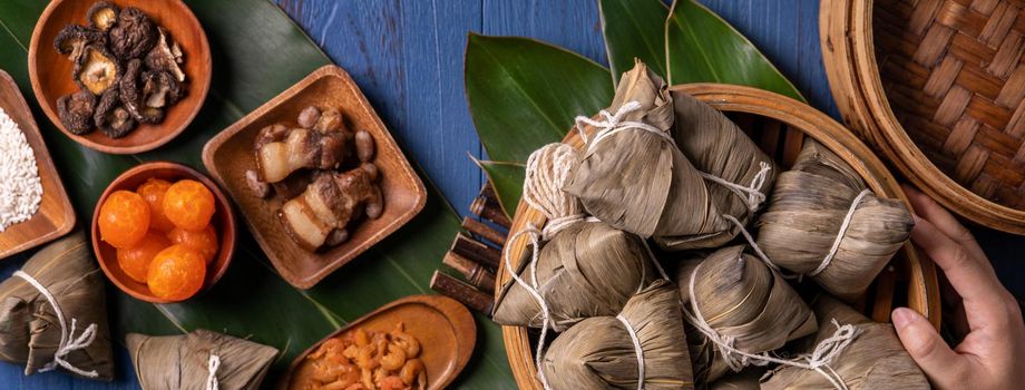 zongzi - Dragon Boat Festival concept Rice dumpling, traditional Chinese food on blue wooden background for Duanwu Festival, top view, flat lay design concept.