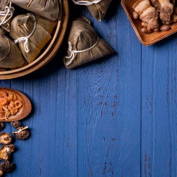 zongzi - Dragon Boat Festival concept Rice dumpling, traditional Chinese food on blue wooden background for Duanwu Festival, top view, flat lay design concept.