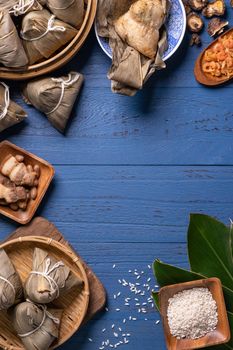 zongzi - Dragon Boat Festival concept Rice dumpling, traditional Chinese food on blue wooden background for Duanwu Festival, top view, flat lay design concept.