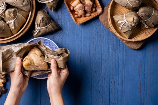 zongzi - Dragon Boat Festival concept Rice dumpling, traditional Chinese food on blue wooden background for Duanwu Festival, top view, flat lay design concept.