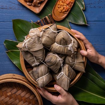 zongzi - Dragon Boat Festival concept Rice dumpling, traditional Chinese food on blue wooden background for Duanwu Festival, top view, flat lay design concept.