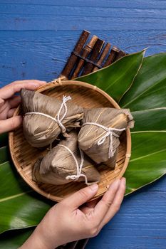 zongzi - Dragon Boat Festival concept Rice dumpling, traditional Chinese food on blue wooden background for Duanwu Festival, top view, flat lay design concept.