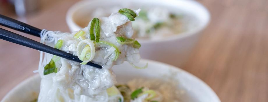 Delicious fish ball rice noodles in thick soup, common food in Tainan, Taiwan, Asia, Asian Taiwanese street delicacy cuisine, close up, lifestyle.