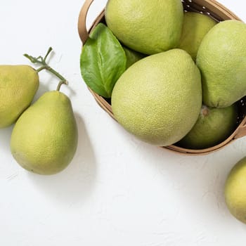Fresh pomelo, pummelo, grapefruit, shaddock on white background, fruit for Mid-autumn festival, top view, flat lay.