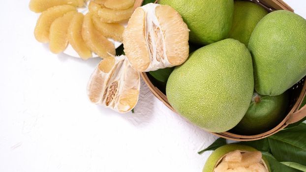 Fresh pomelo, pummelo, grapefruit, shaddock on white background, fruit for Mid-autumn festival, top view, flat lay.