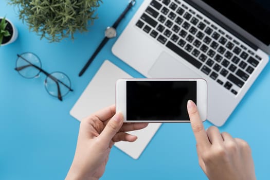 Social network connecting office table concept with fashion accessories, minimal interior with a woman holding smartphone, top view, flat lay, mockup, copy space