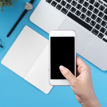 Social network connecting office table concept with fashion accessories, minimal interior with a woman holding smartphone, top view, flat lay, mockup, copy space