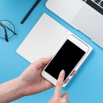 Social network connecting office table concept with fashion accessories, minimal interior with a woman holding smartphone, top view, flat lay, mockup, copy space
