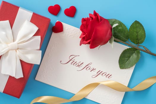 Concept of beautiful Valentine's day, anniversary, mother's day and birthday present and greetings on blue background, copyspace, topview, mockup